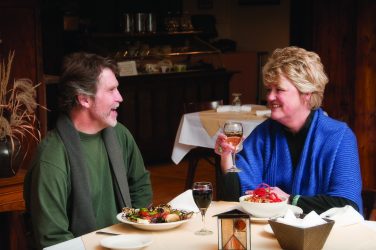 A couple enjoys dinner at The Belton Chalet in West Glacier.