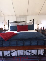 The bed inside the glamping cabin. 