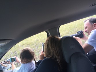 Three photographers exploring Montana. Sidenote: the car was in park, off and not moving when this picture was taken. 