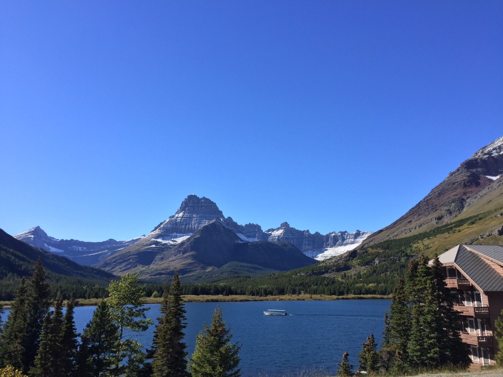 Two Guns (Glacier Park Boat Company's wooden boat) heading to the head of Swiftcurrent Lake. 